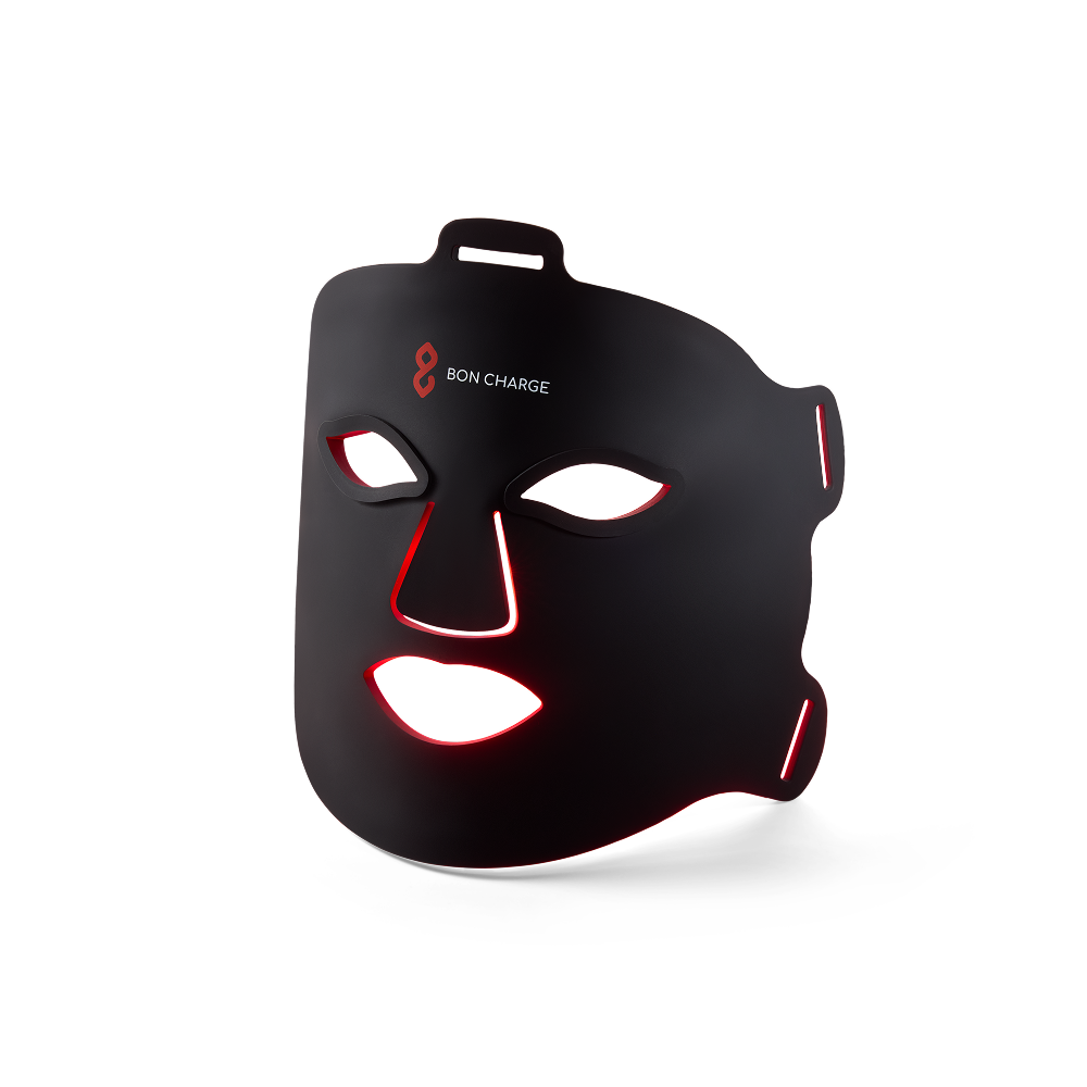 The black Bon Charge Red Light Face Mask with a soft red glow around the edges