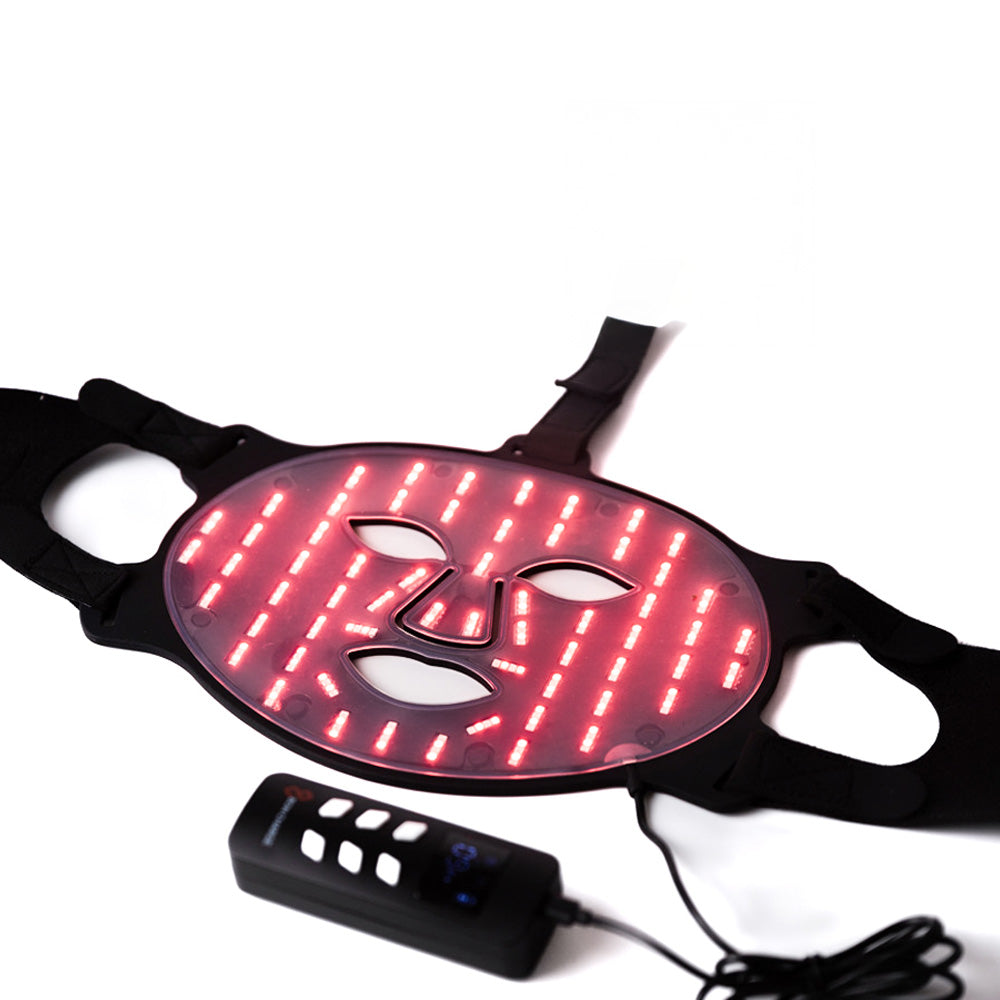 Bon Charge mask lit up with rows of red LEDs next to its cordless controller