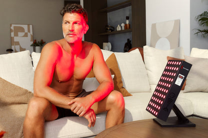 Man Sitting in Front of Demi Red Light Therapy Device