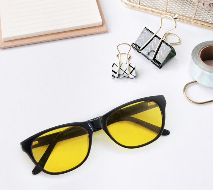 Light sensitivity glasses yellow lenses on table