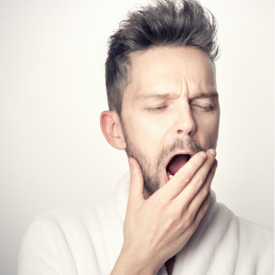 Man yawning, looking tired after sleep